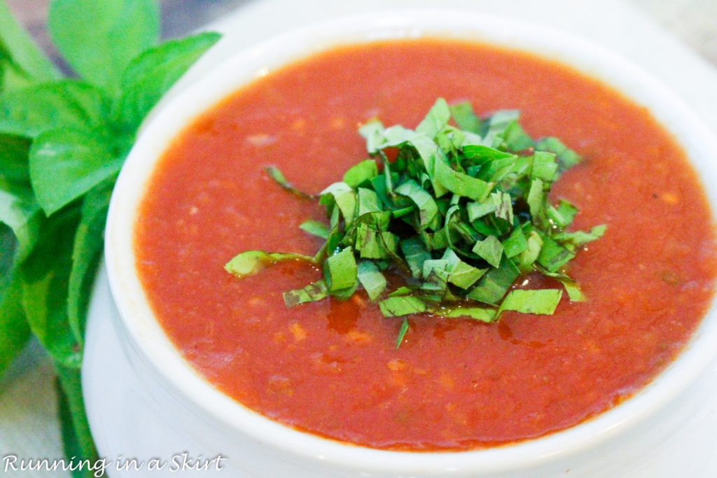 crock pot tomato basil soup recipe with basil on top.