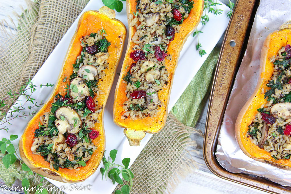 Finished product Vegetarian Stuffed Butternut Squash on a white plate with herbs.