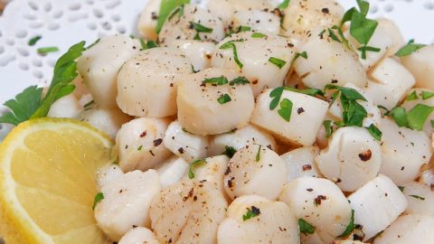 Bay Scallops recipe on a white plate.