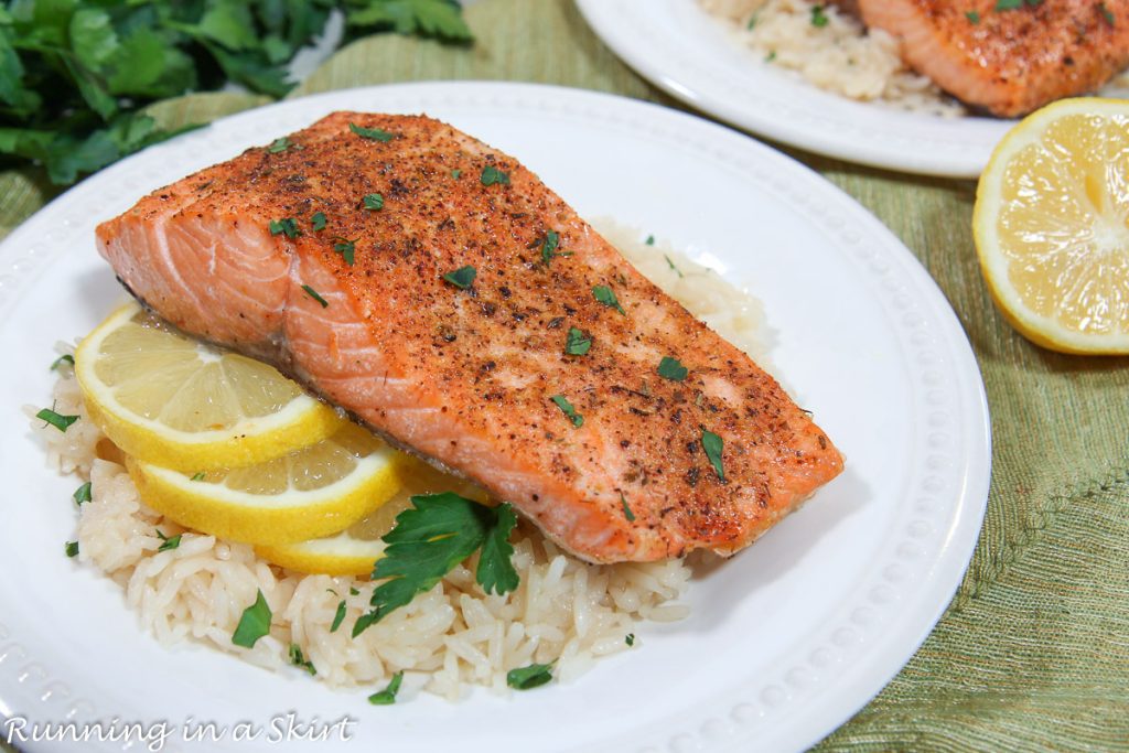Steelhead Trout recipe on a white plate with rice.